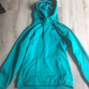 A turquoise Nike hoodie with a high neck